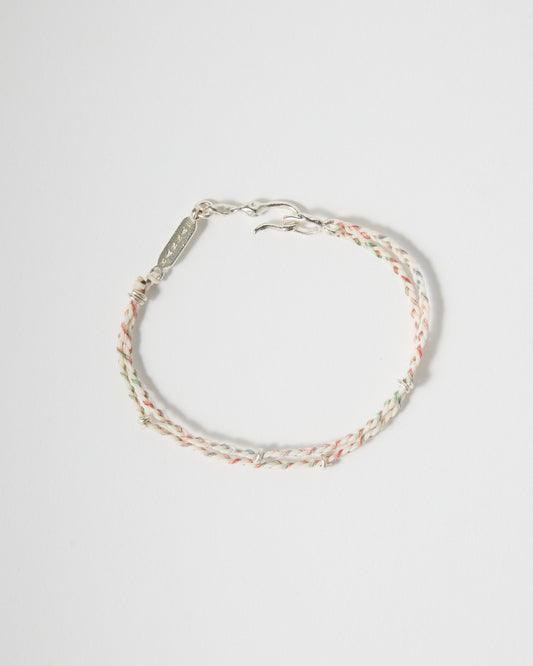 Handmade braided bracelet featuring cream, blush pink, mint, and pale blue threads with sterling silver details