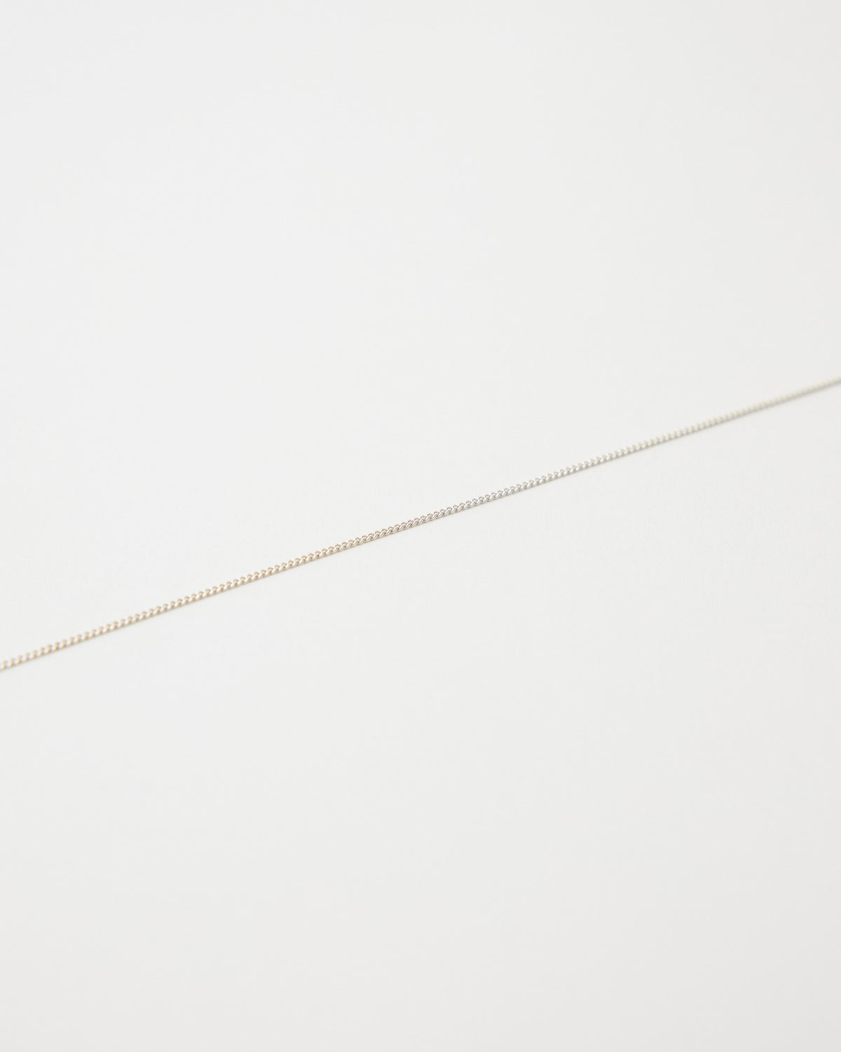 Close-up of a 1mm sterling silver curb chain – HANNA543 B1045 whisper curb chain