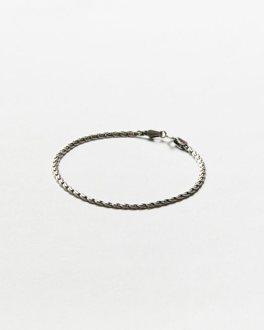Minimal sterling silver chain bracelet featuring a refined woven link design on clean white background, designed for everyday wear and effortless layering.