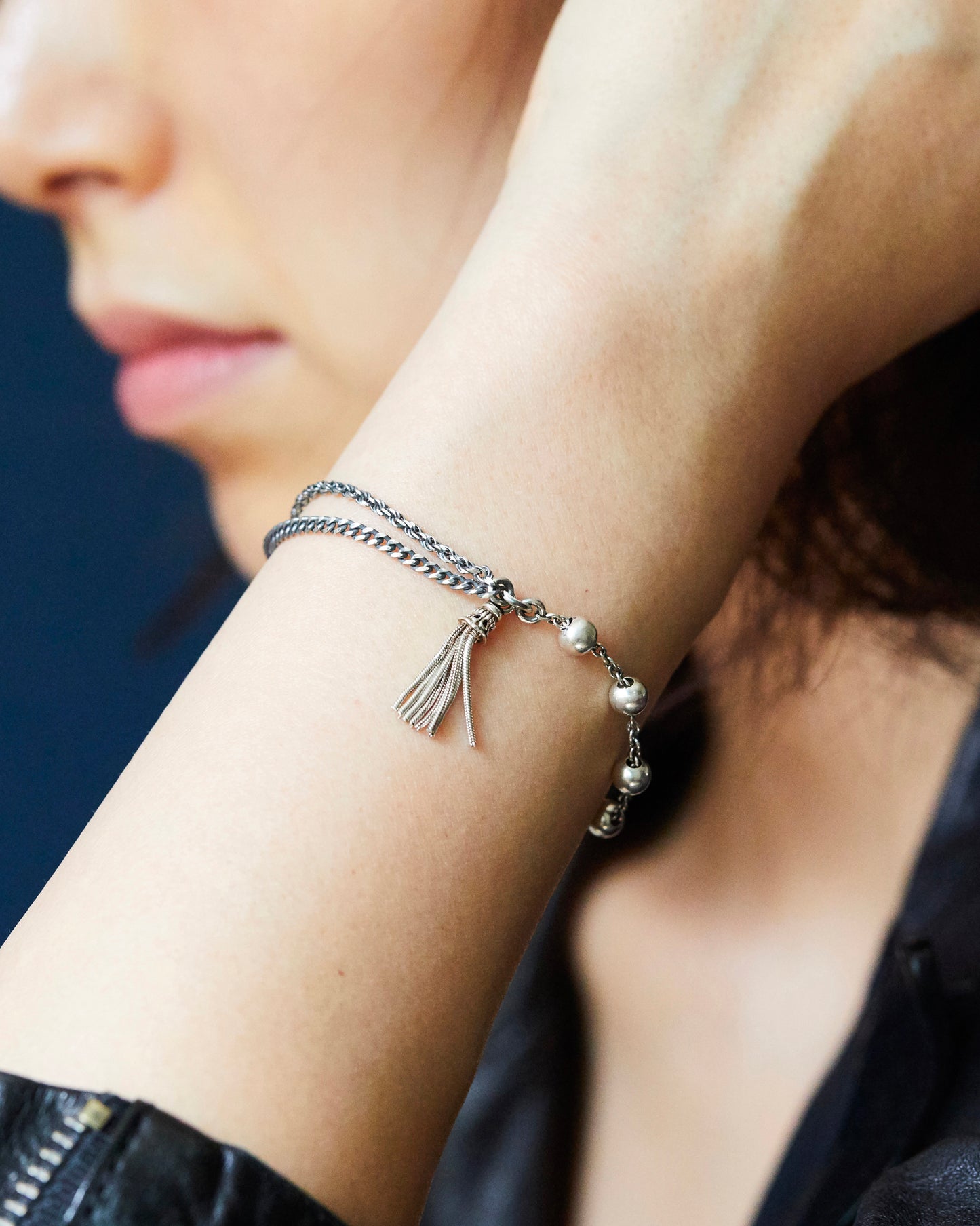 silver tassel bracelet styled on wrist with soft natural skin tone