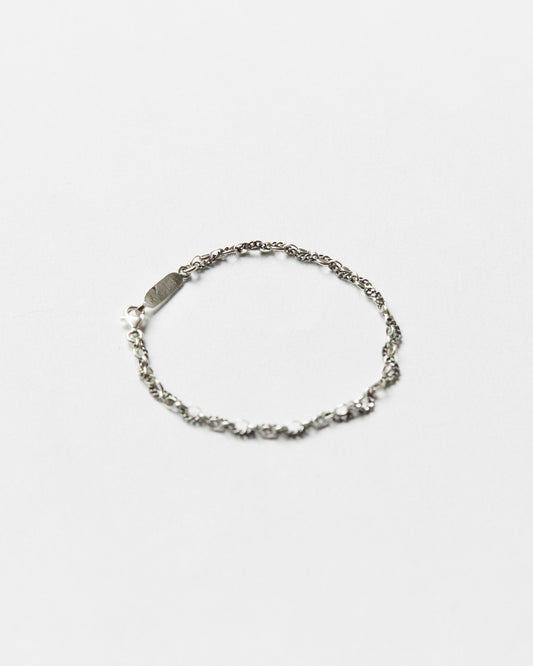 Minimal sterling silver mixed-link bracelet on white background