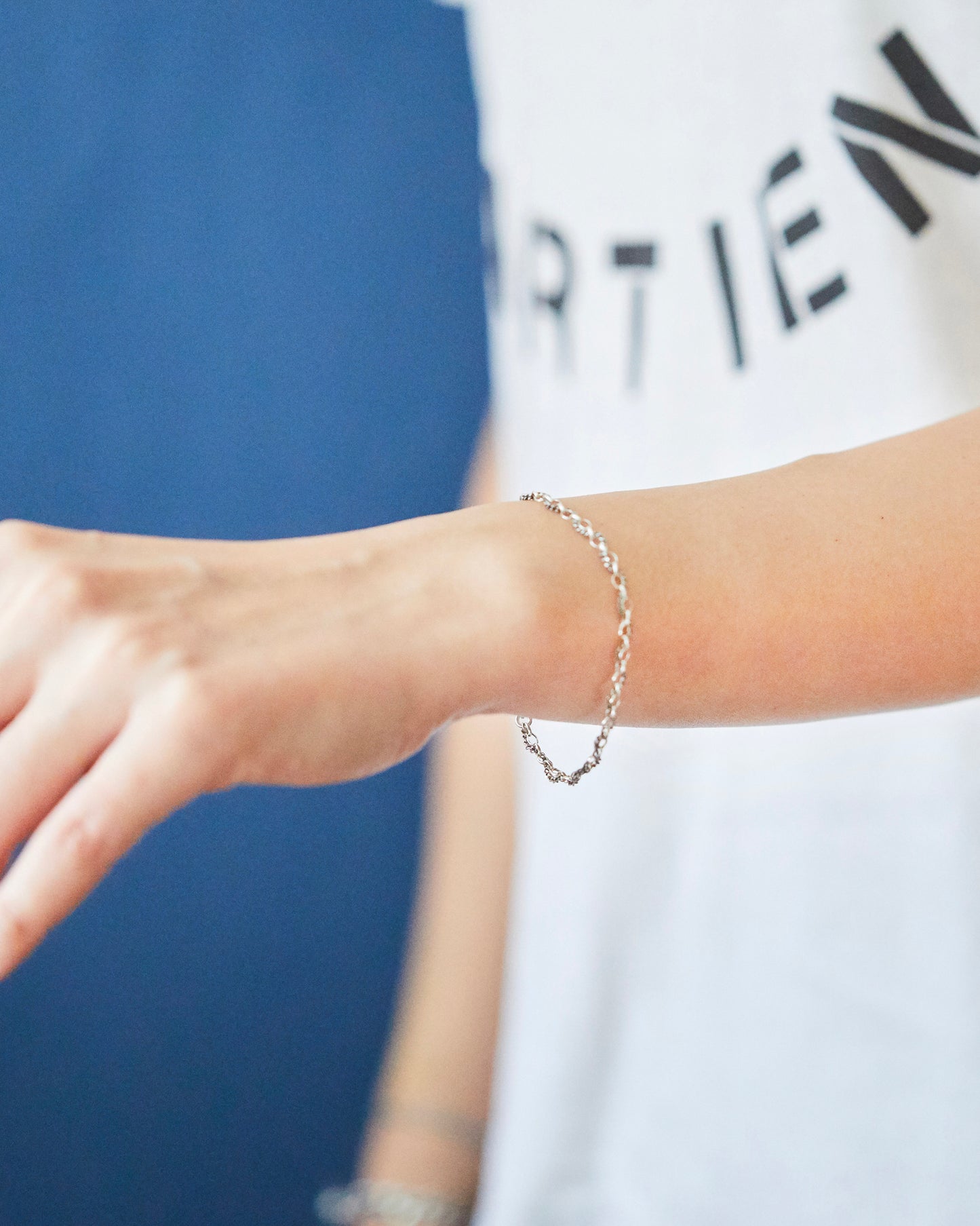 Minimal sterling silver chain bracelet worn on wrist for everyday styling