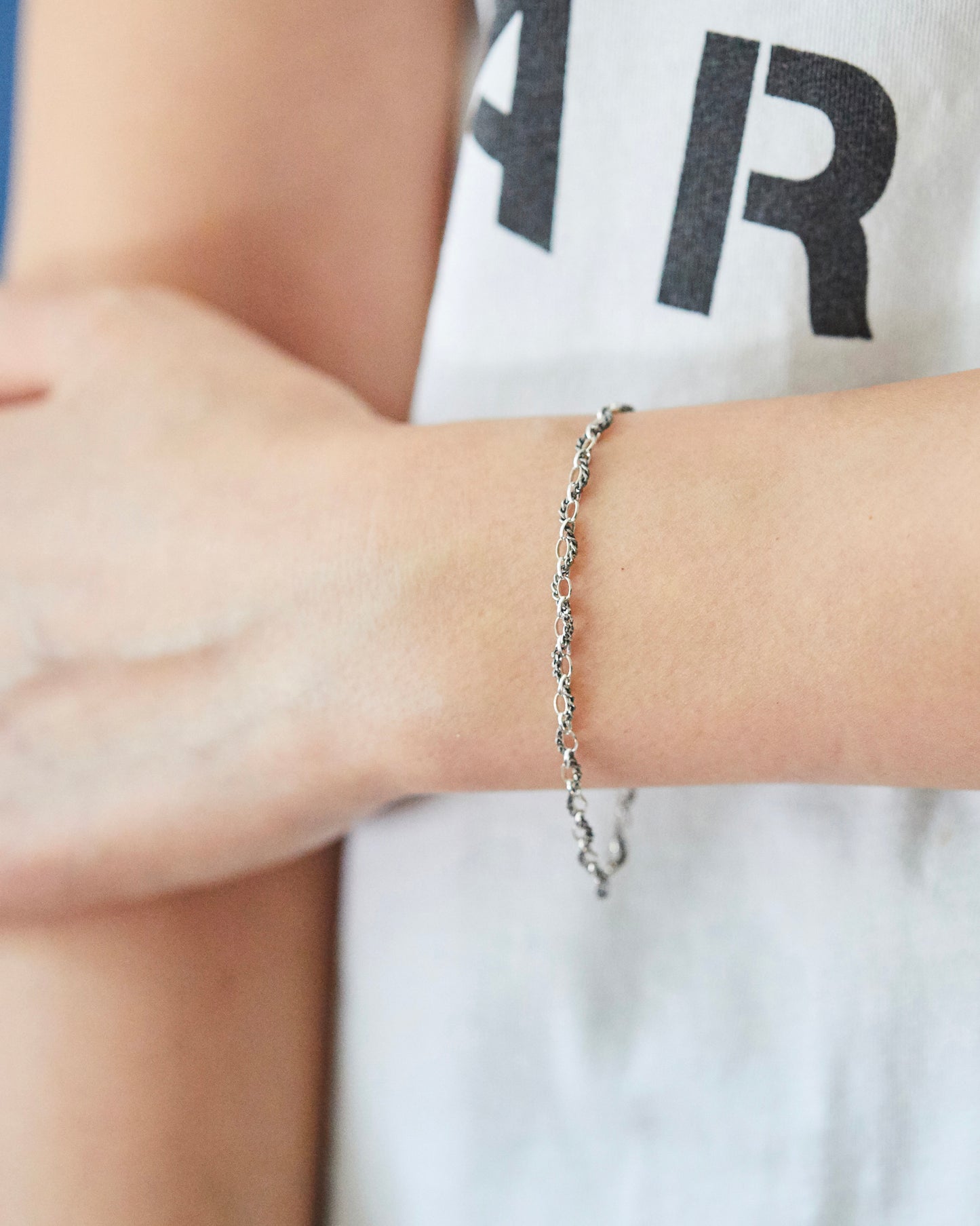 Delicate sterling silver bracelet styled on wrist with effortless everyday look