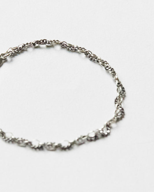 Detailed view of textured sterling silver mixed-link bracelet chain