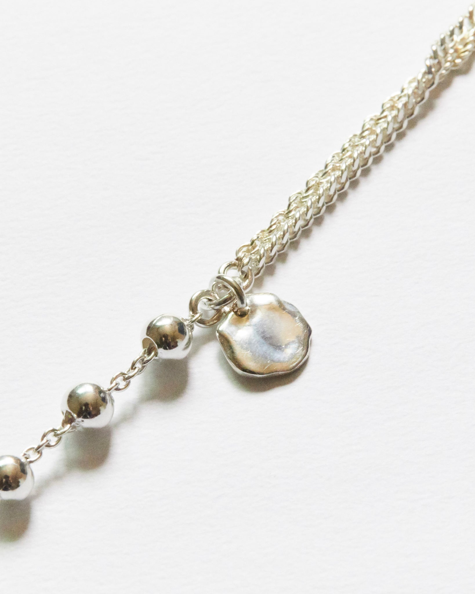 close up silver bead chain bracelet with organic charm detail minimal texture jewelry