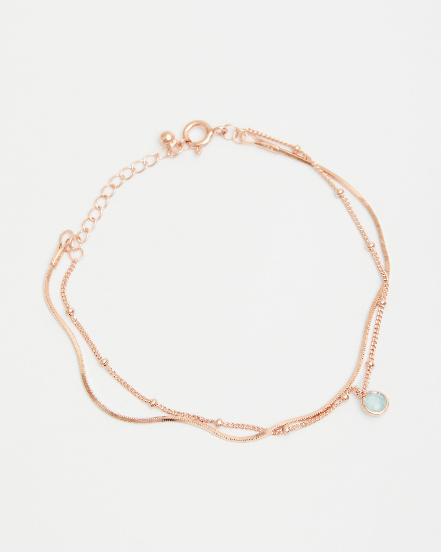 Minimal rose gold layered chain bracelet with soft blue charm
