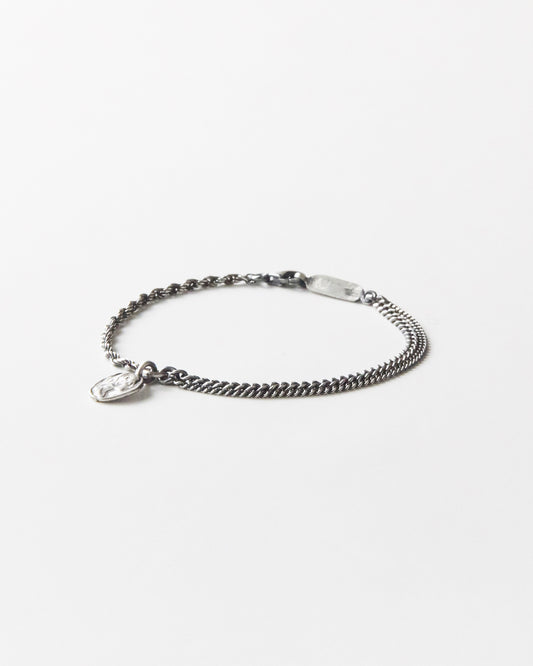925 silver bracelet with dual chain detail and textured coin pendant on white background