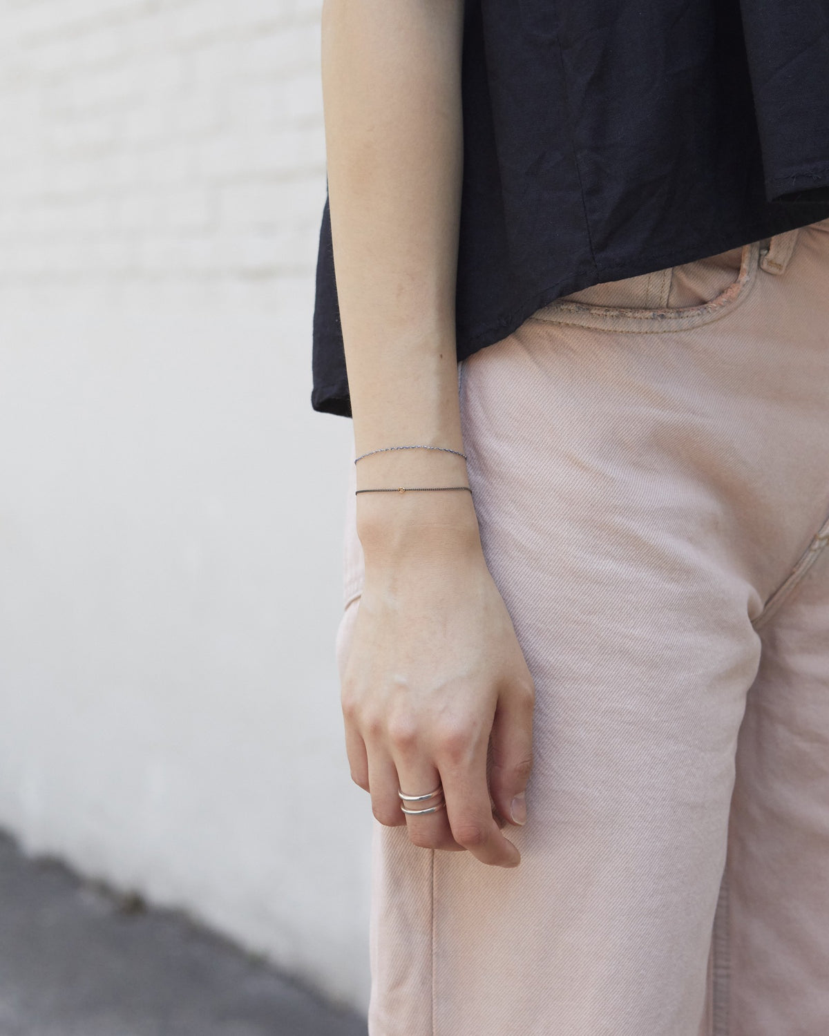 Antique silver chain bracelet with a gold accent worn on the wrist, full outfit view – HANNA543 B535 gold note chain