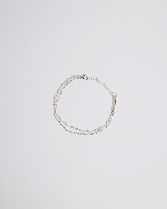 Top view of silver layered pearl bracelet with delicate chain and tiny pearl details