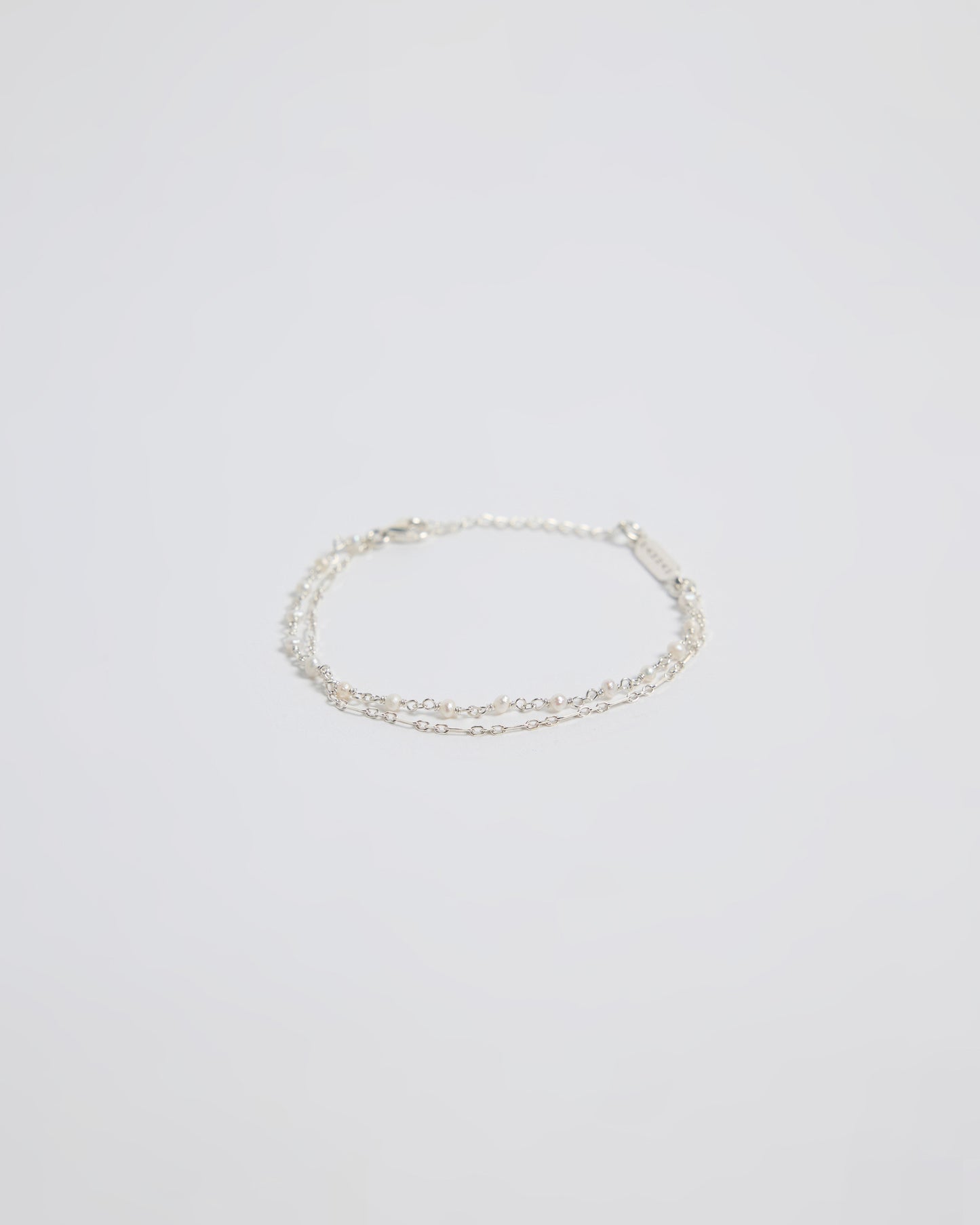 Minimal silver double layered pearl bracelet isolated on white background
