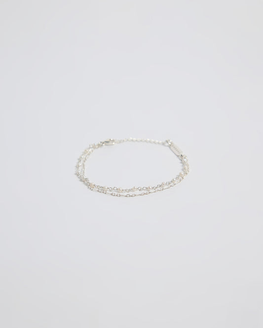 Minimal silver double layered pearl bracelet isolated on white background