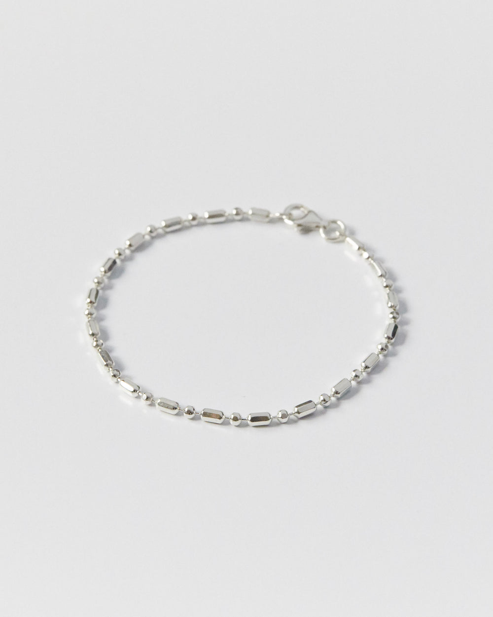architectural silver bracelet with alternating bead and bar links, minimal geometric design