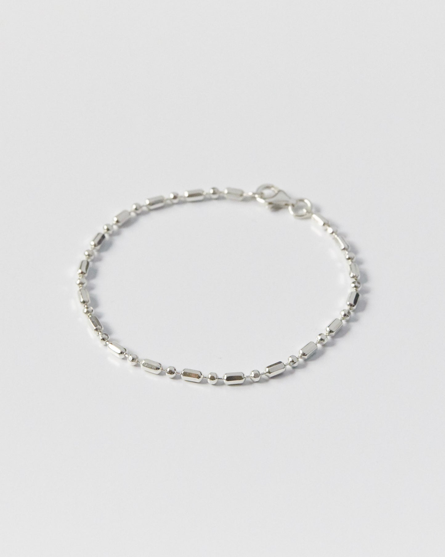 architectural silver bracelet with alternating bead and bar links, minimal geometric design