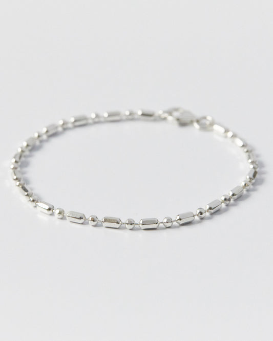 silver bracelet composed of modular bead and bar elements, clean and balanced form
