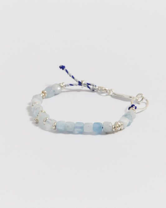 Full product shot of the beaded bracelet laid in a curved shape