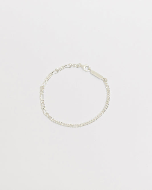 Sterling silver mixed link bracelet featuring alternating elongated and curb chain details with polished finish on white background.