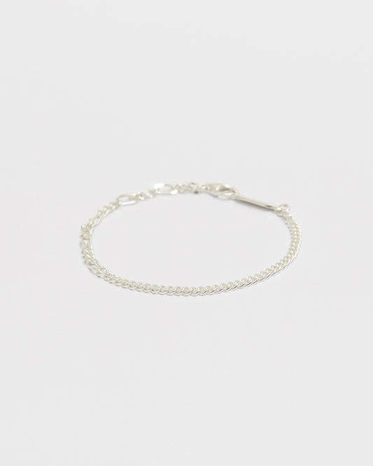 Minimal sterling silver mixed chain bracelet featuring delicate curb links and elongated chain details on a clean white background for everyday wear.