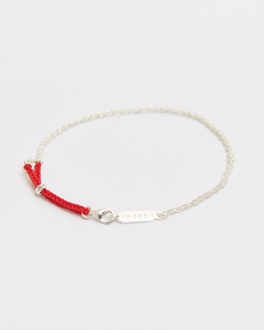 Sterling silver chain bracelet with braided red cord detail designed for minimalist everyday styling.