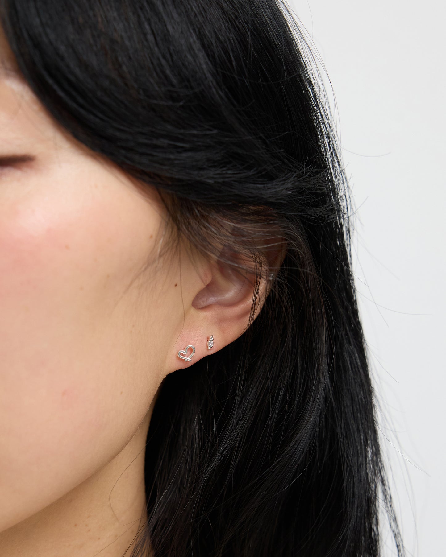 polished silver stud earring highlighting smooth metal texture and refined stone setting