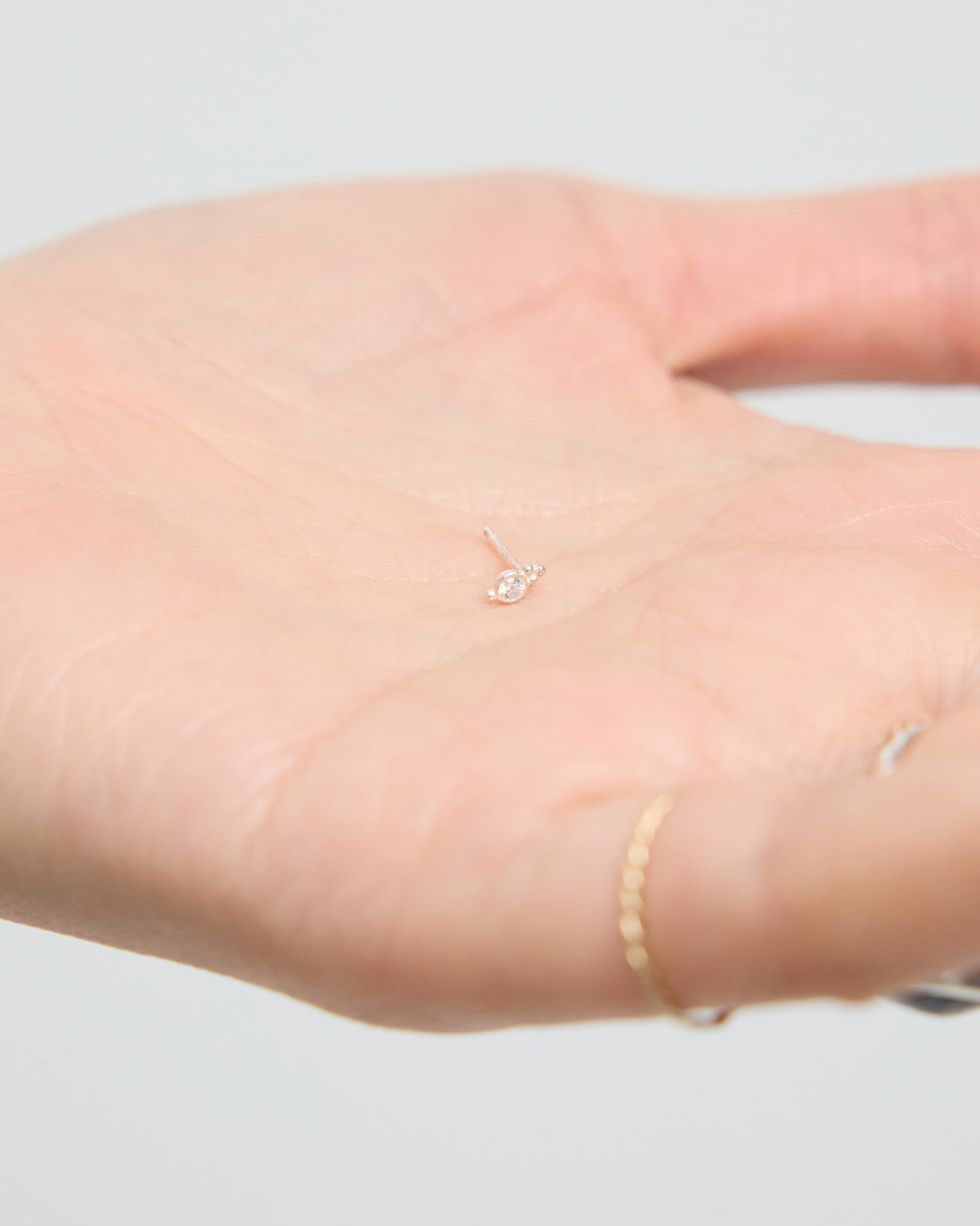 silver stud earring with small centered stone, minimalist everyday jewelry