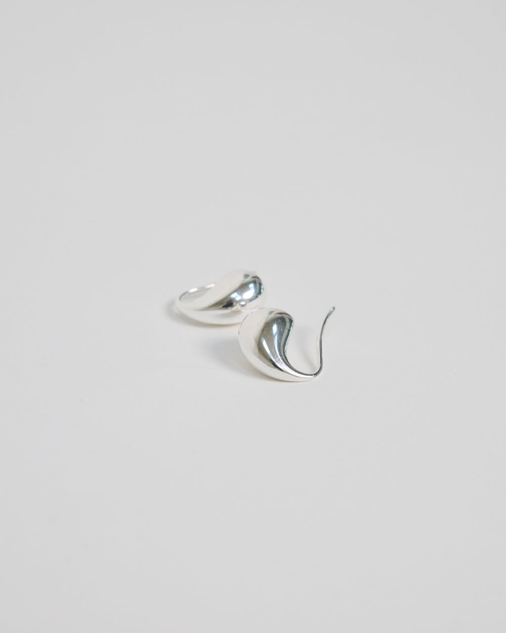 Pair of HANNA543 high-polish 925 sterling silver bold teardrop earrings, handcrafted in Korea for a sleek modern look.
