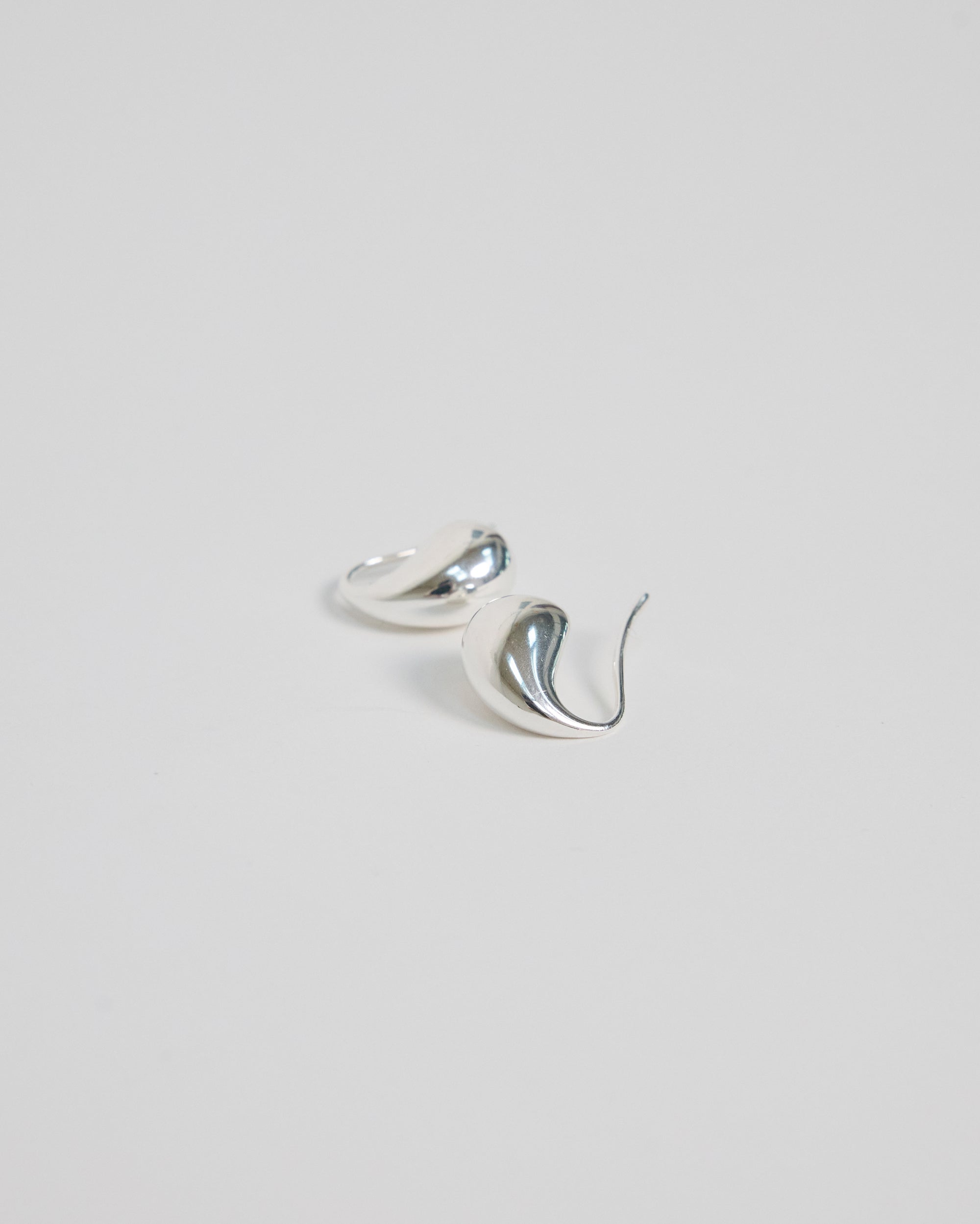 Pair of HANNA543 high-polish 925 sterling silver bold teardrop earrings, handcrafted in Korea for a sleek modern look.