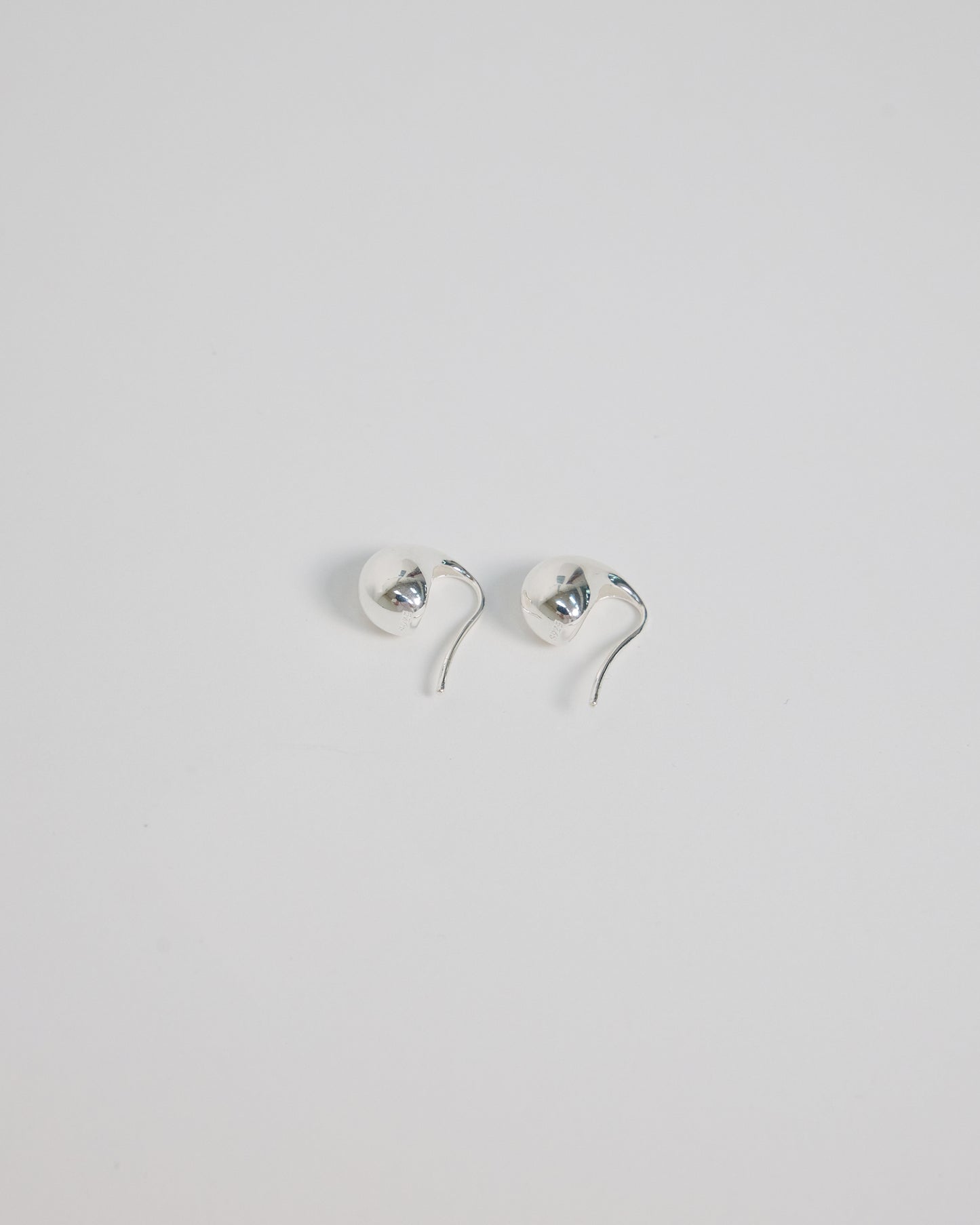 Silver curved hook earrings backside view, clean minimal construction