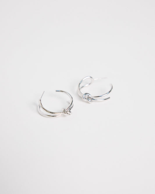 pair of silver hoop earrings on a light gray background