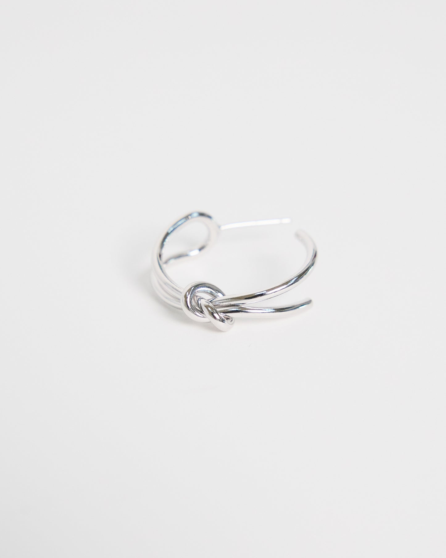 silver ring with a knot design on a white background