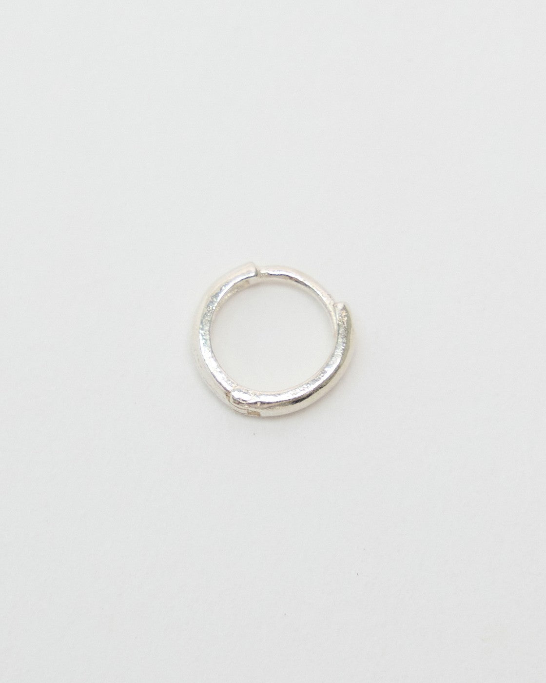 Tiny 5mm sterling silver huggie hoop earring with a softly textured band, front view – HANNA543 E155 soft halo huggie