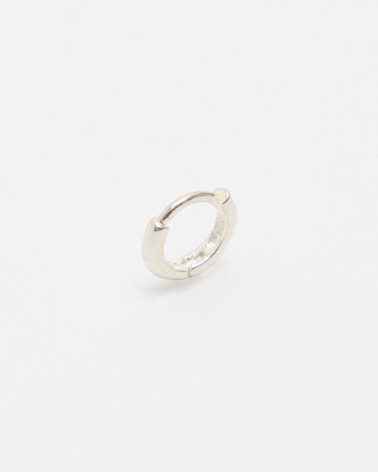 Sterling silver mini huggie hoop earring shown at an angle – HANNA543 E155 soft halo huggie