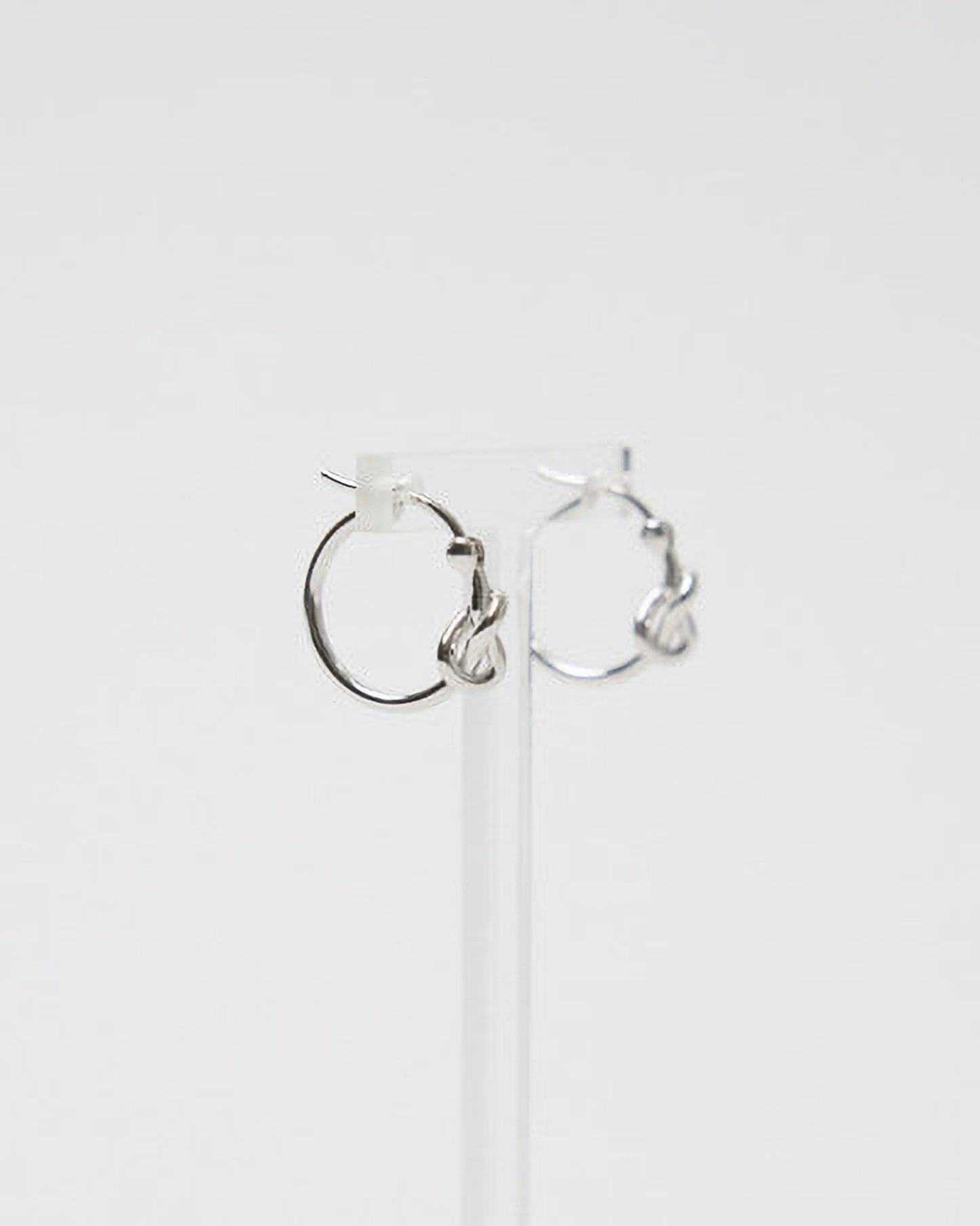 Silver hoop earrings on a white background