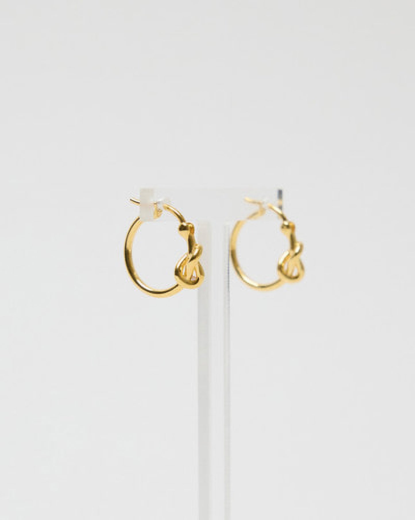 Gold hoop earrings on a white background