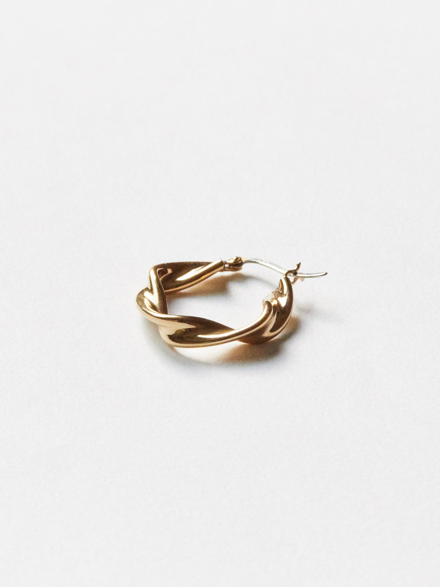 detail gold earring on a white background