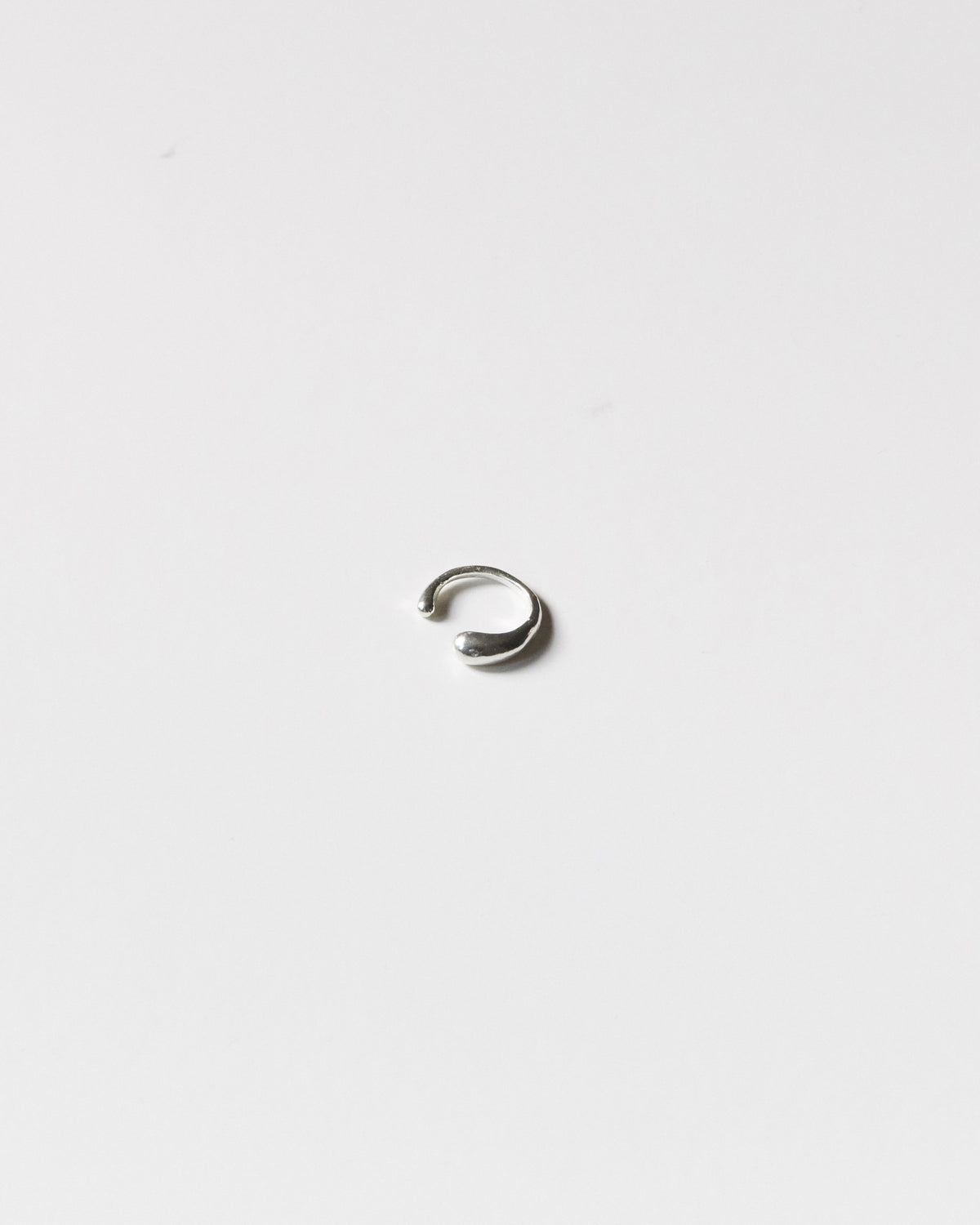 Sterling silver drop ear cuff on a light gray background – HANNA543 E735 falling drop cuff