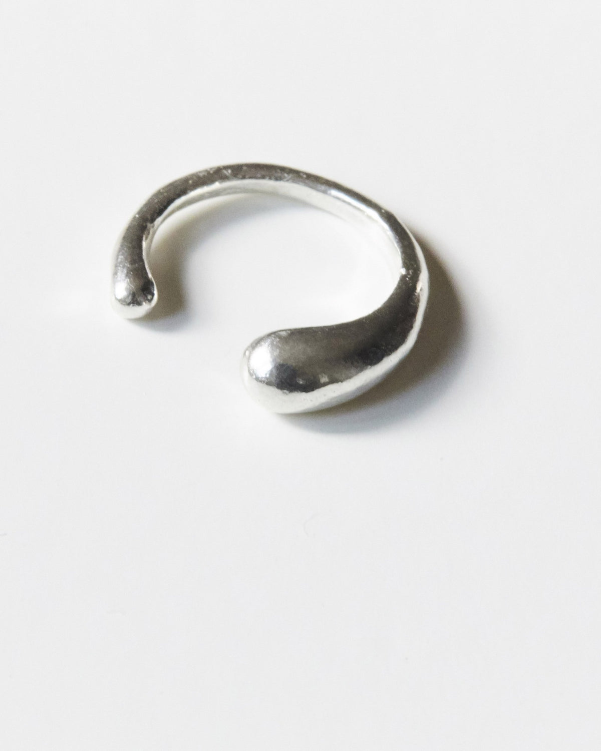 Close-up of a polished sterling silver ear cuff with a teardrop end – HANNA543 E735 falling drop cuff