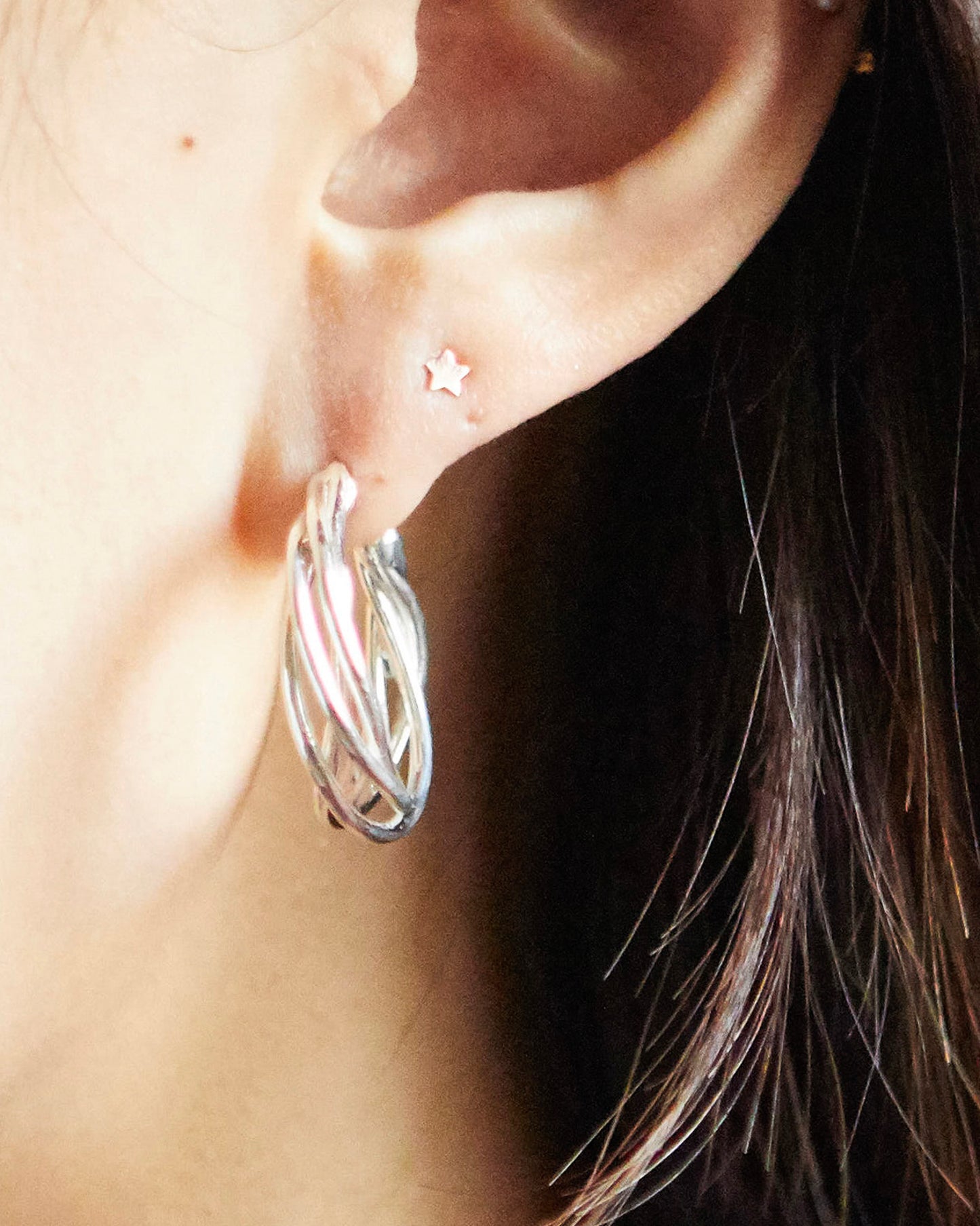 styling of HANNA543 E783 silver spiral earrings on ear. minimalist unisex jewelry look inspired by BTS JIMIN style