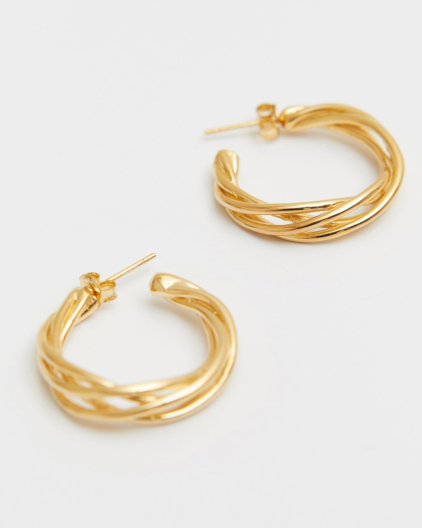 Gold hoop earrings on a white background