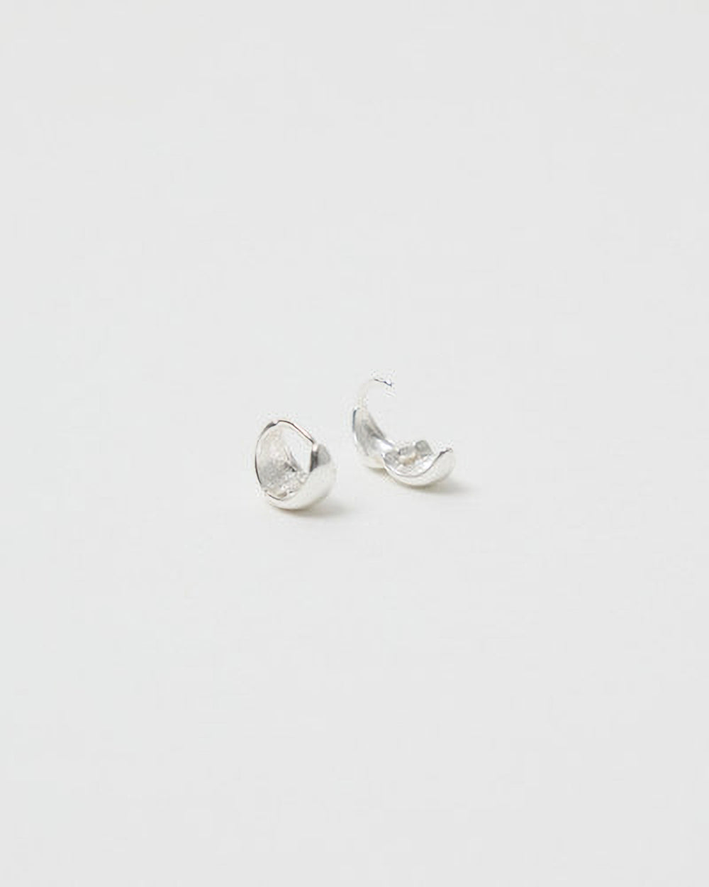 Pair of silver earrings on a light gray background