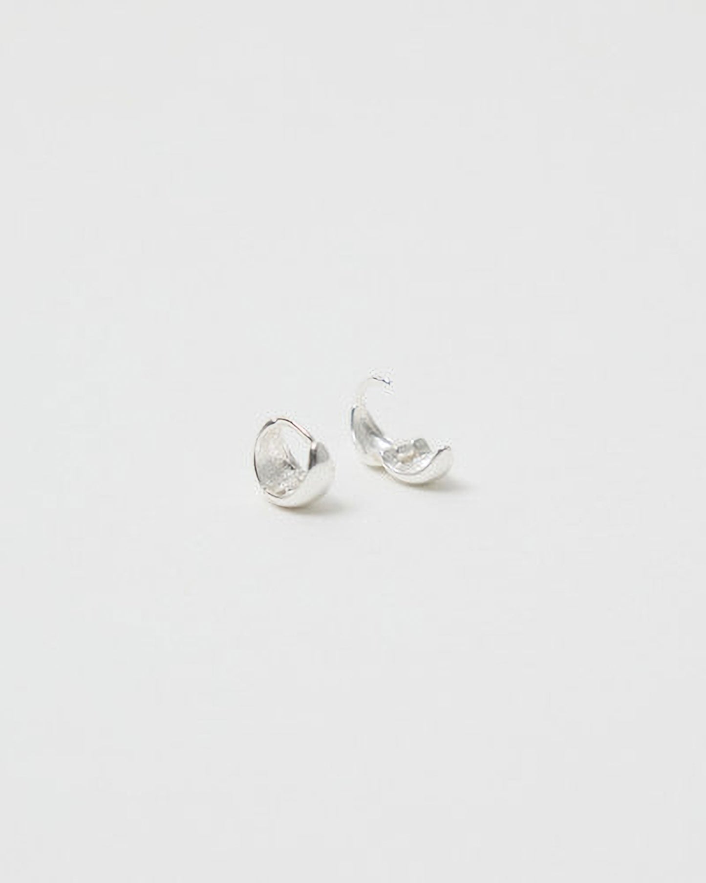 Pair of silver earrings on a light gray background