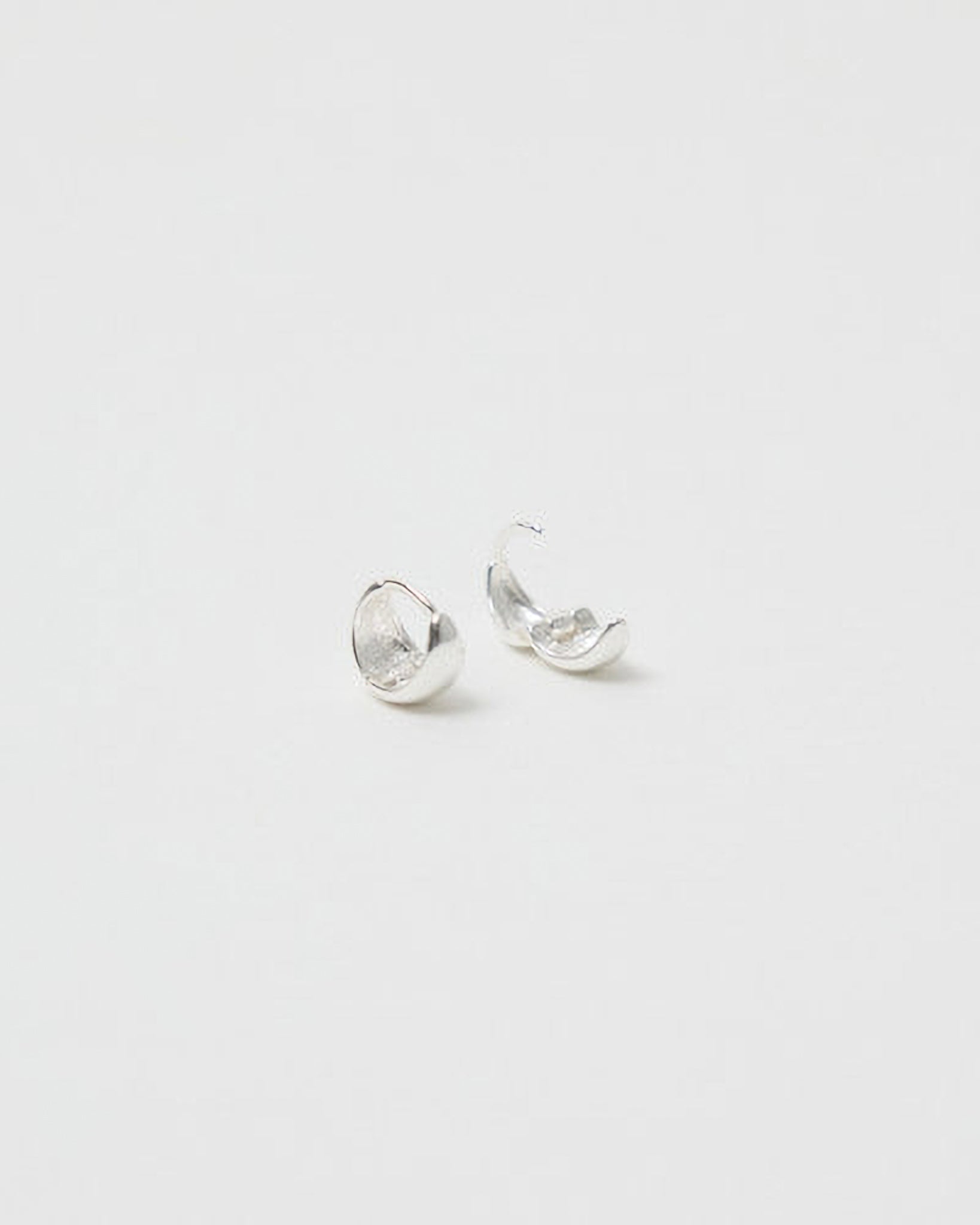 Pair of silver earrings on a light gray background