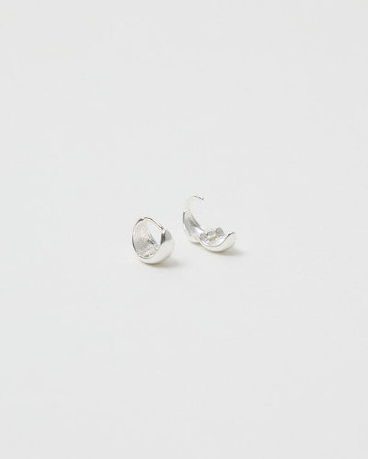 Pair of silver earrings on a light gray background