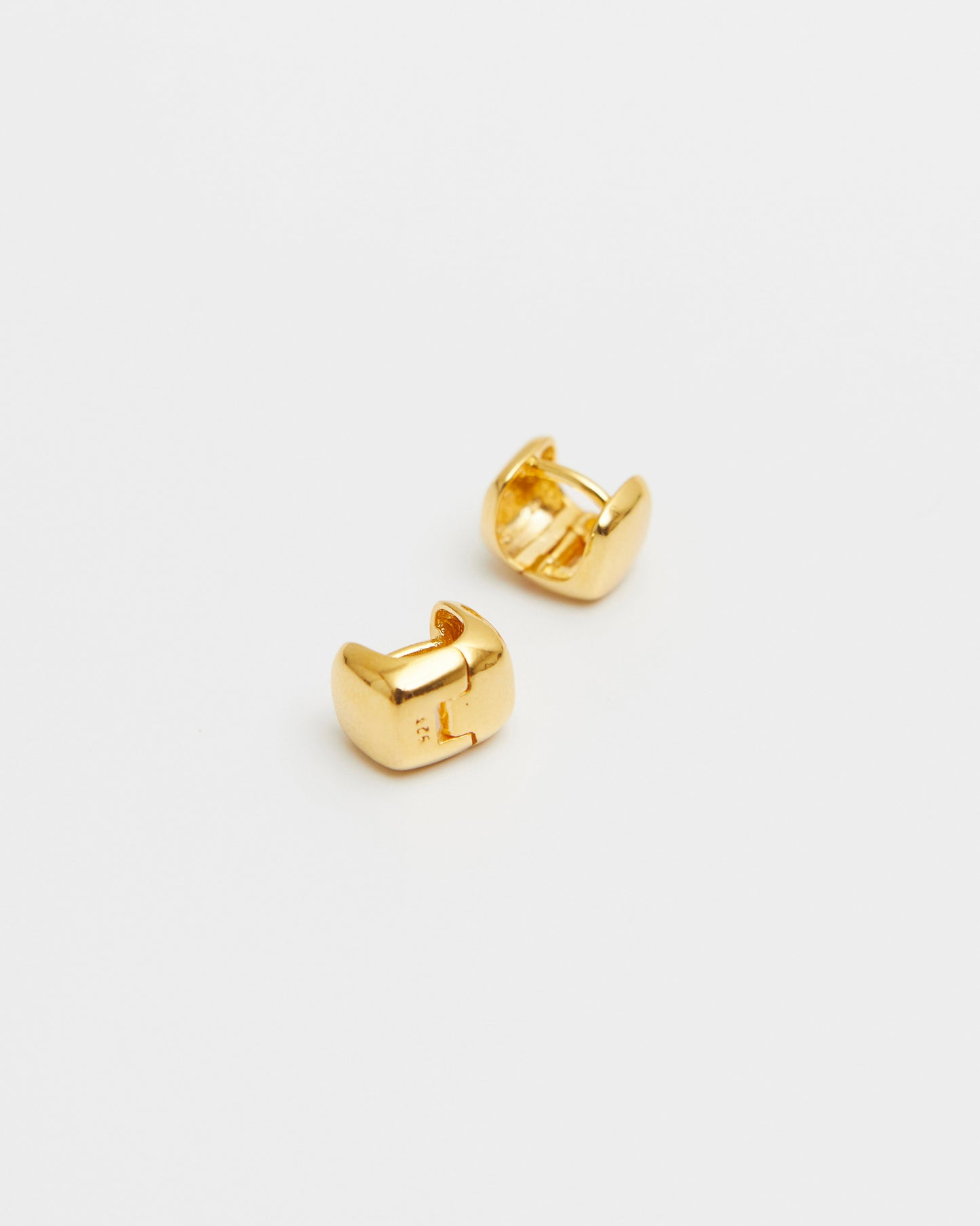 pair of gold square stud earrings on white background, polished rounded cube shape, minimal gold jewelry