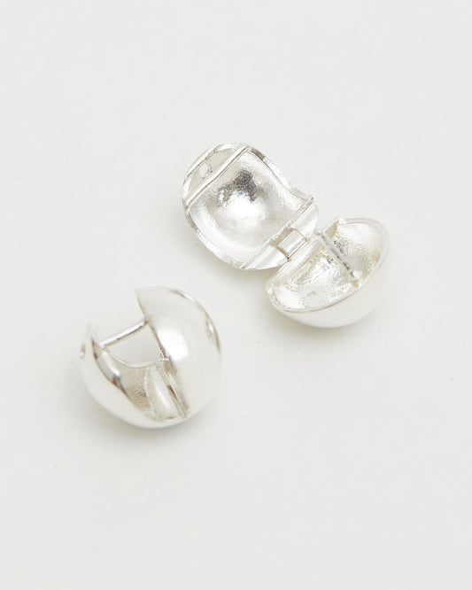 silver dome stud earrings open hinge structure minimal modern jewelry detail