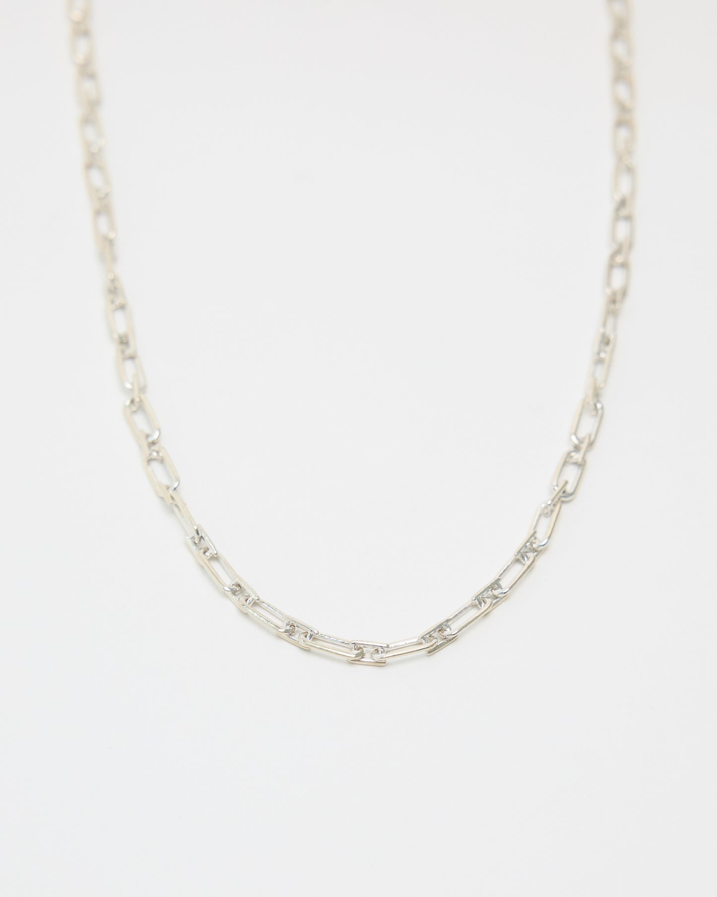 sterling silver link necklace on white background, long chain necklace design, modern minimalist style, versatile silver jewelry for layering or solo wear