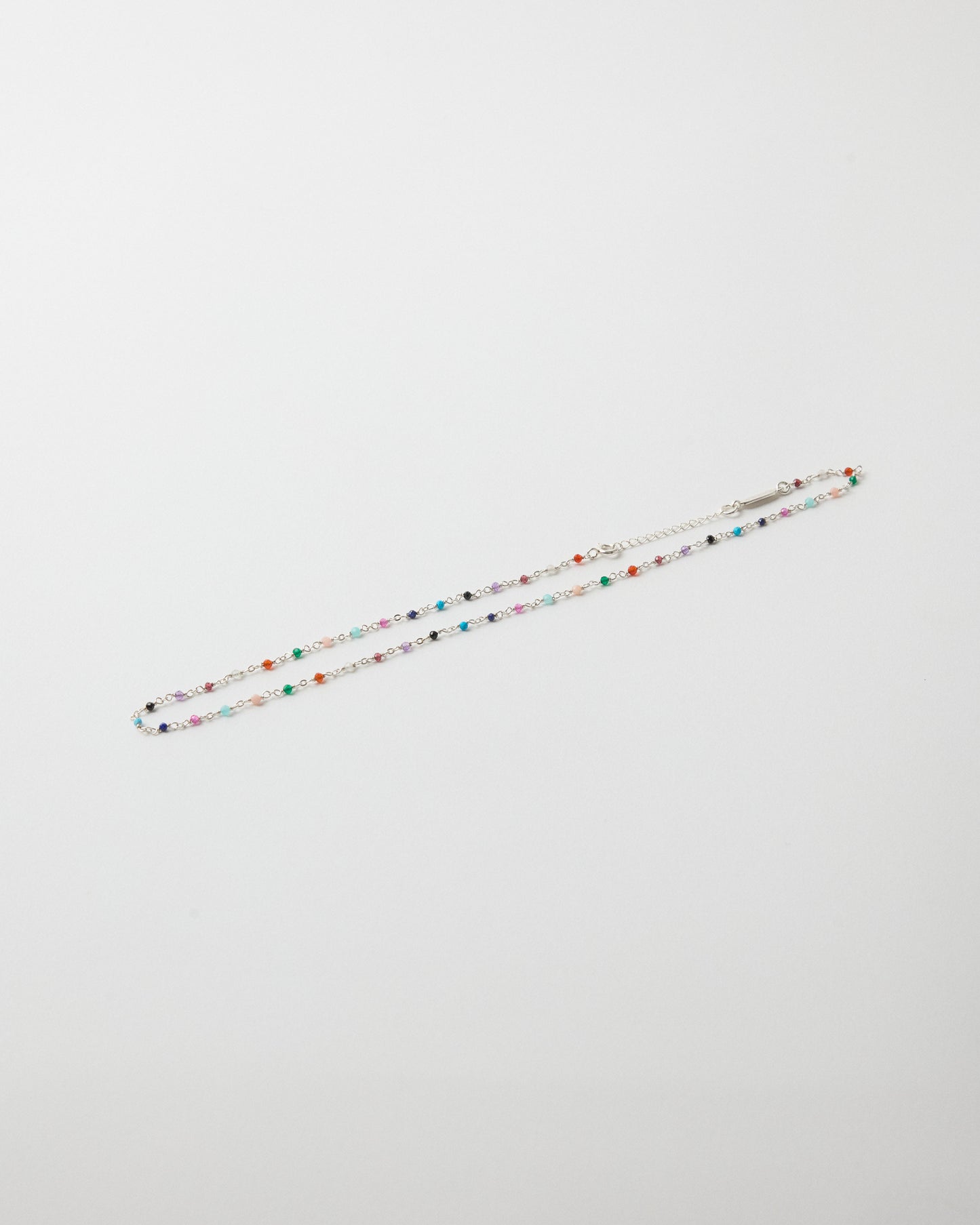 Hanging sterling silver gemstone necklace with rainbow-colored stone accents