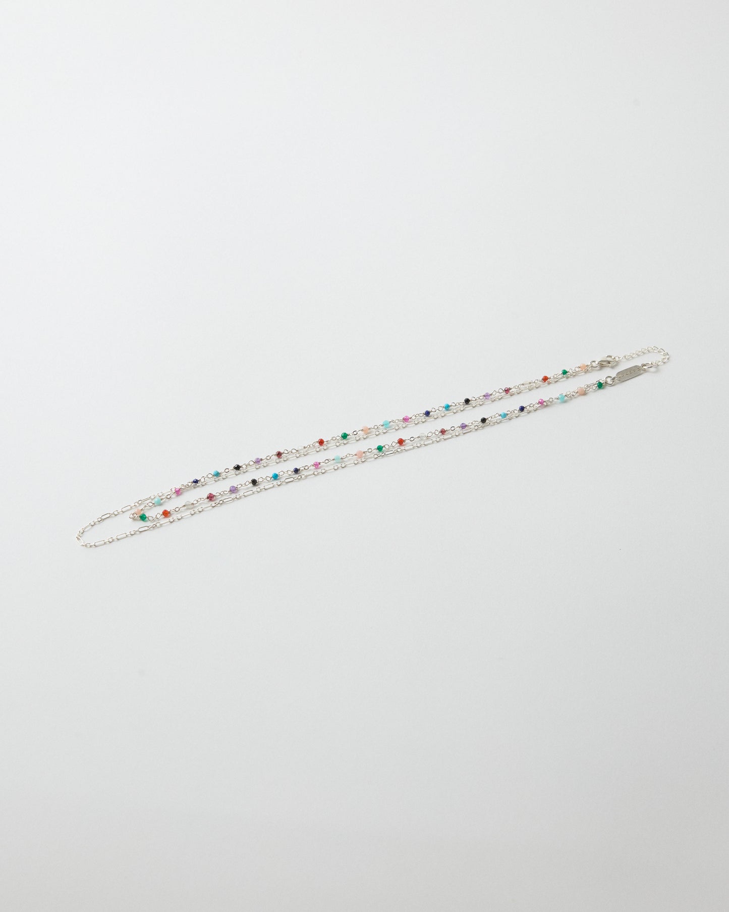 Double-layer sterling silver necklace featuring colorful gemstones and paperclip chain