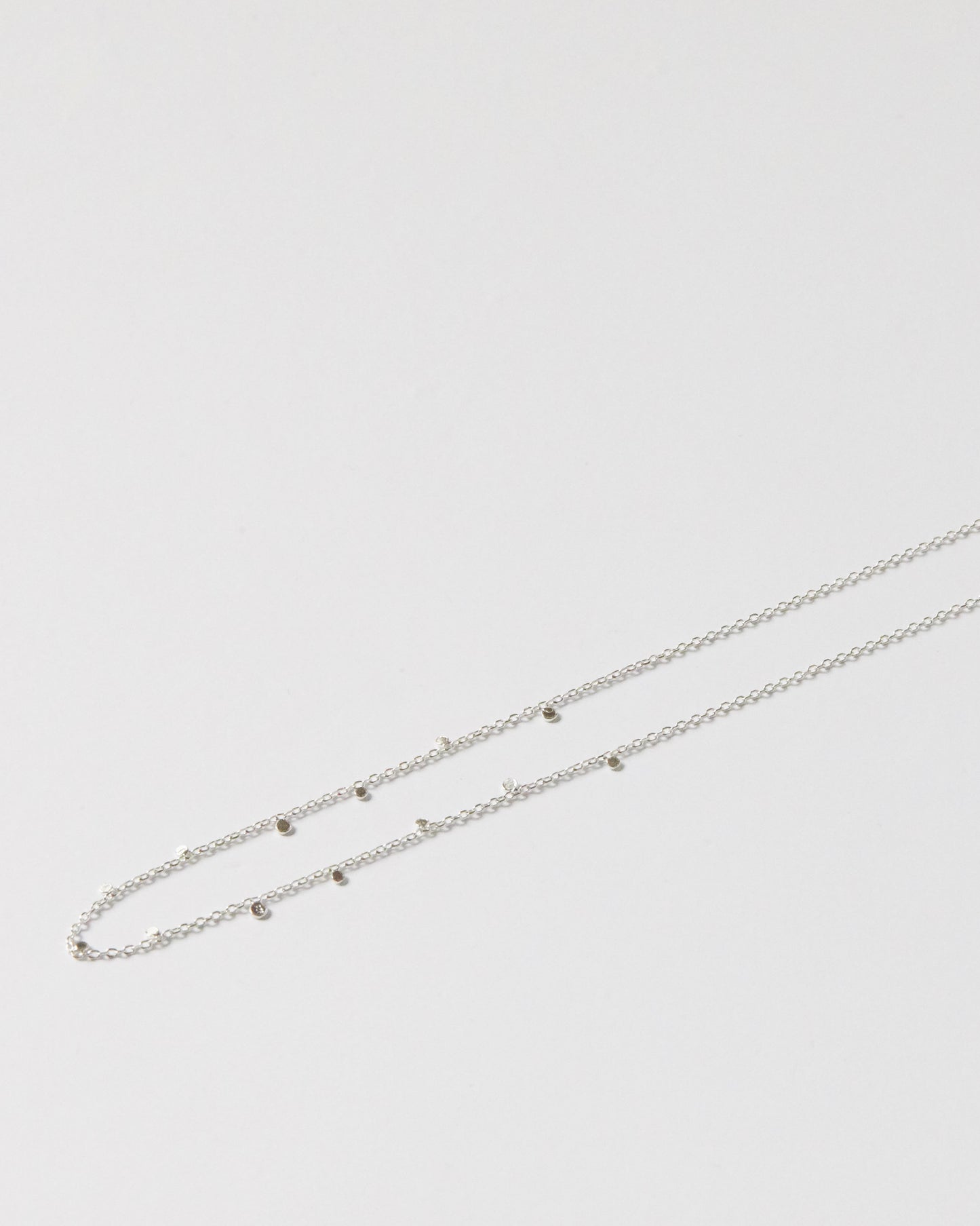Close-up of gold chain necklace resting on skin with subtle shine