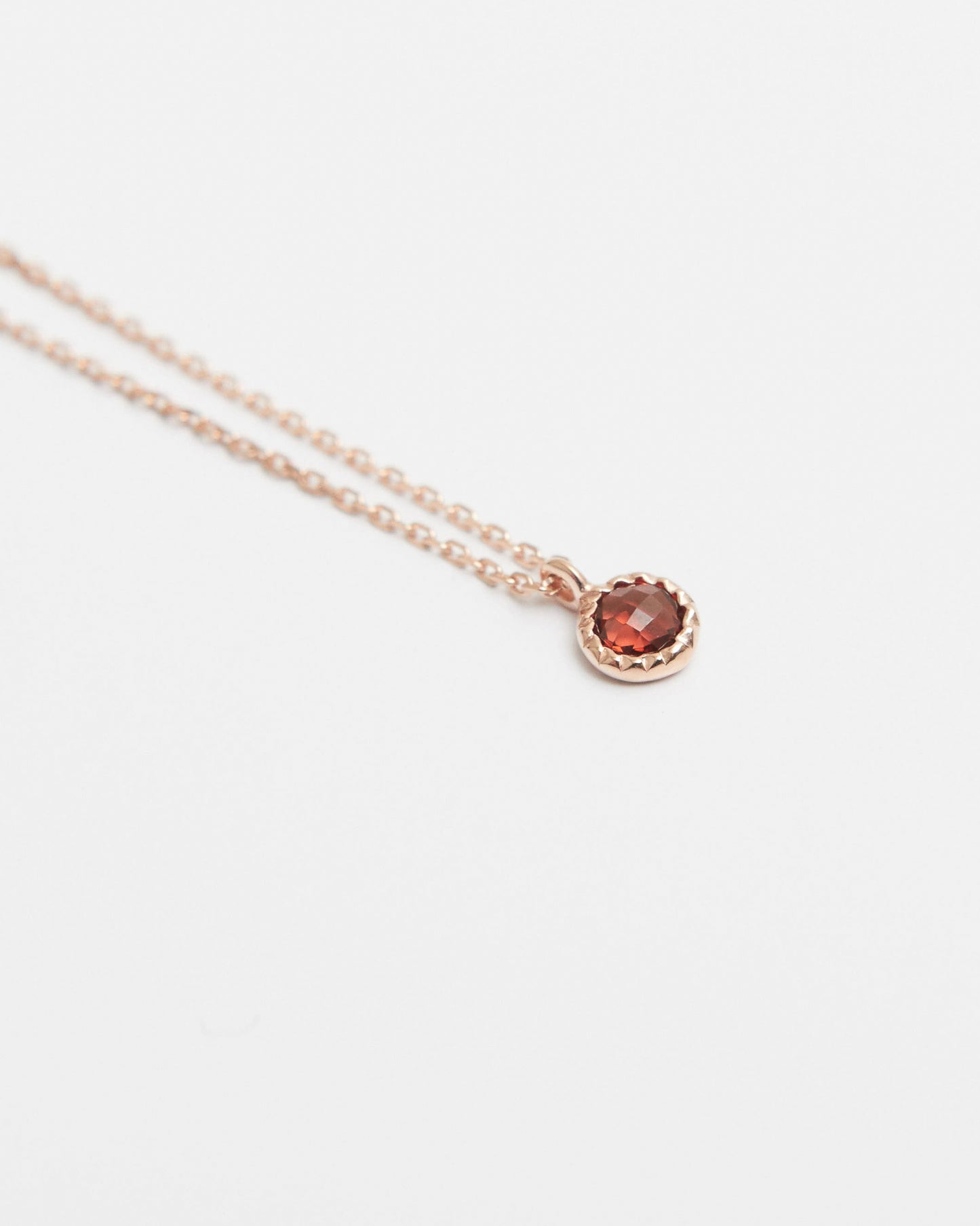 Necklace with a round gemstone on a light gray background