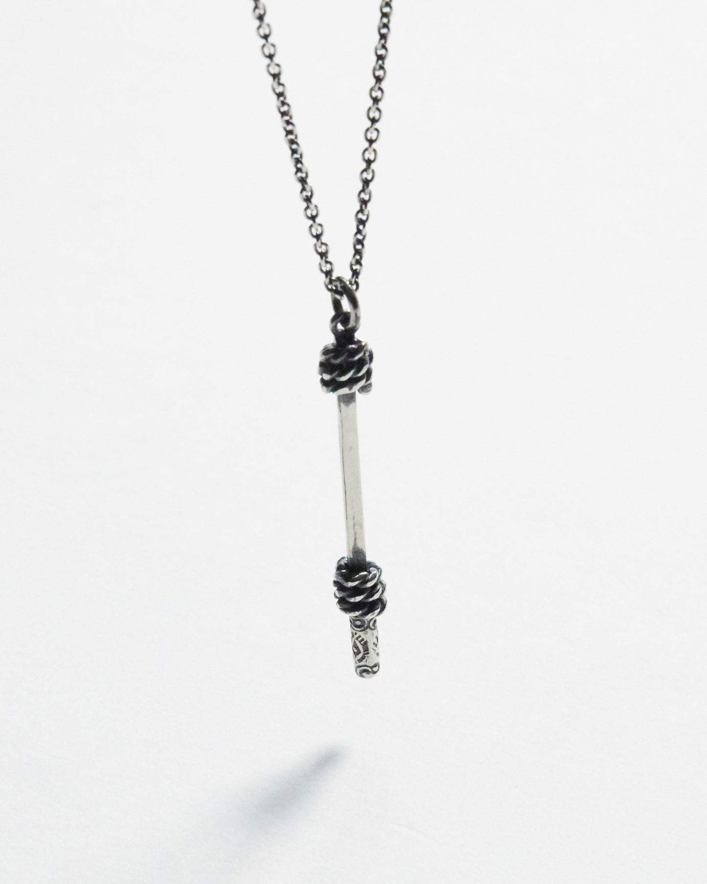 antique silver necklace with a unique pendant on a white background